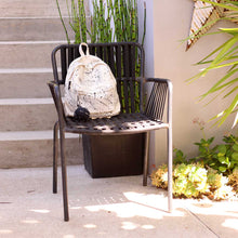 Severina Kids hand painted backpack on a chair
