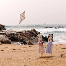Severina Kids Dolls flying a kite in the beach
