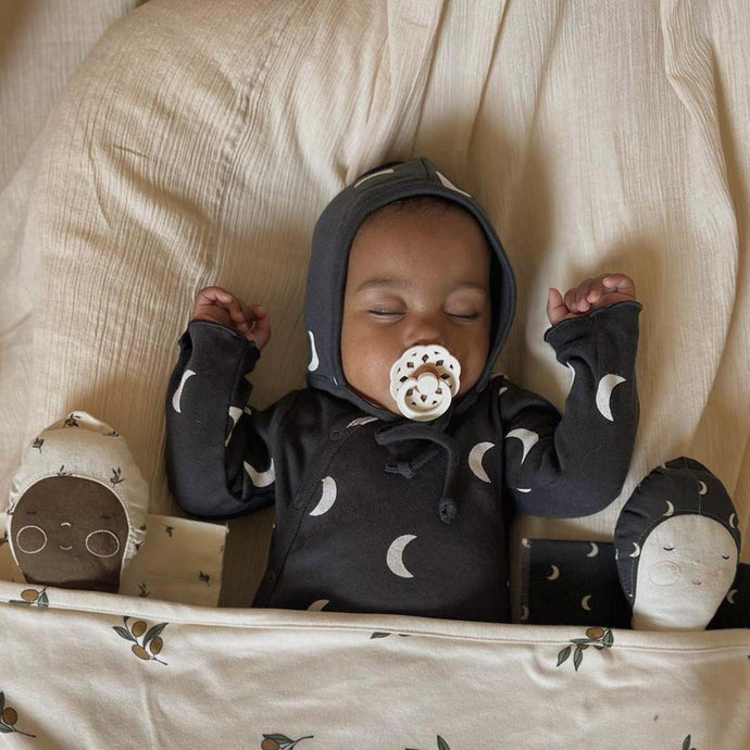 Baby sleeping with Zoonie dolls